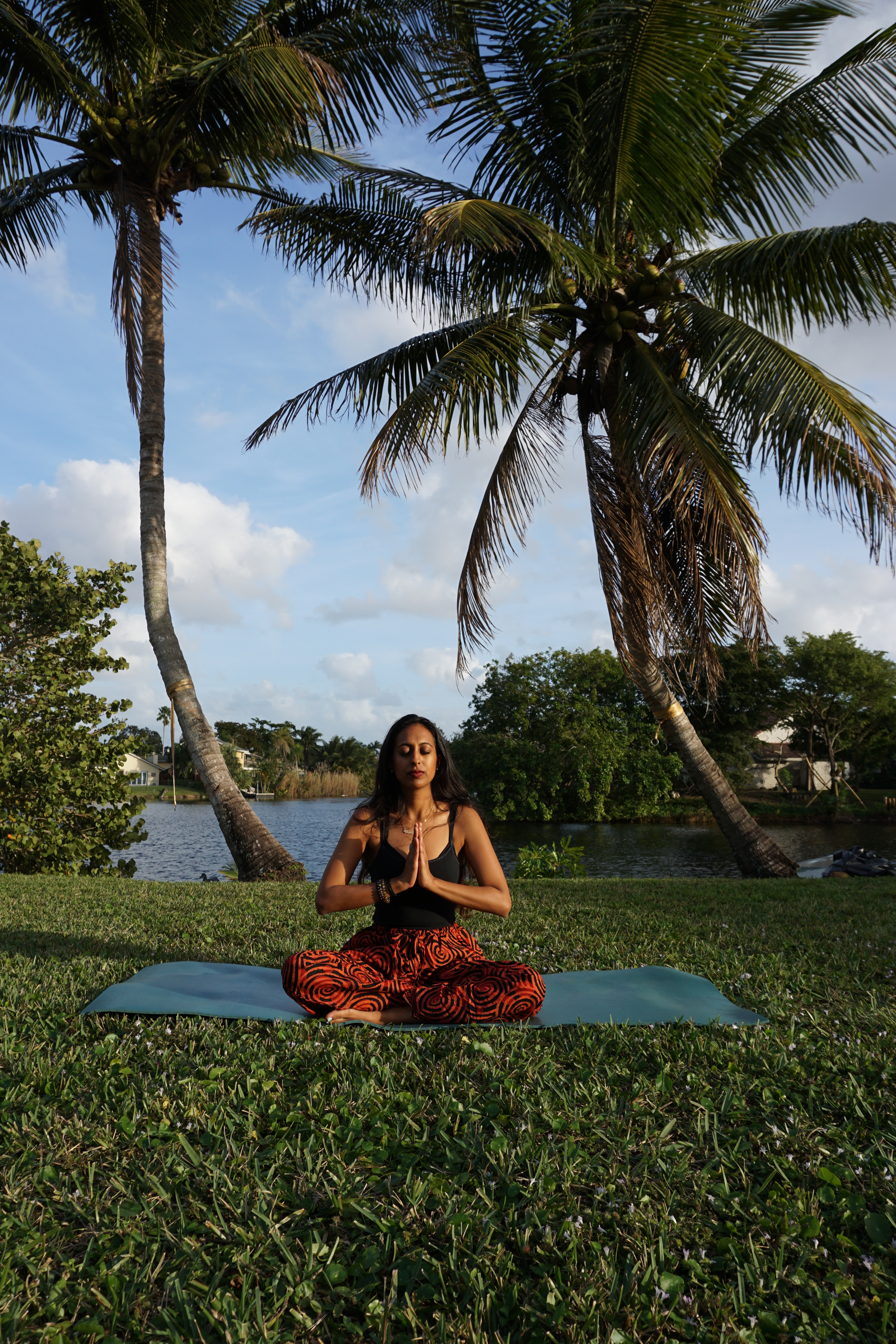 Chahna practicing meditation outdoors, reflecting harmony between personal wellness and the natural world