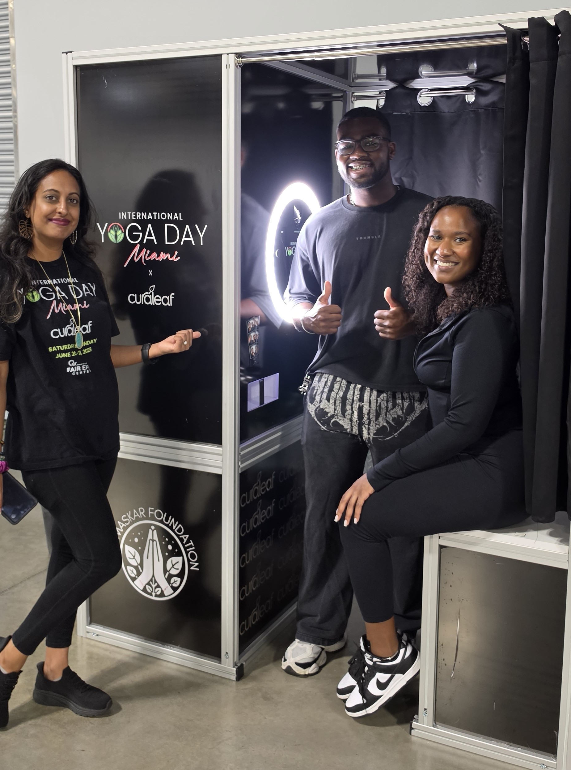 International Yoga Day Miami volunteers welcoming guests at a community event photo booth